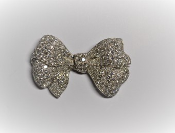 A diamond bow brooch.  Mid 20th Century